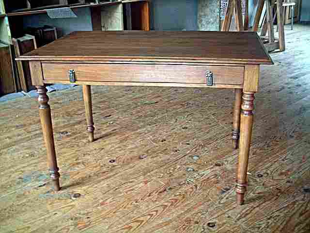 Table bureau en noyer et hêtre, grand tiroir en façade, pieds tournés.