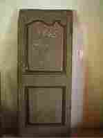 Une porte de bonnetière rustique, moulurée, en pin à restaurer.
